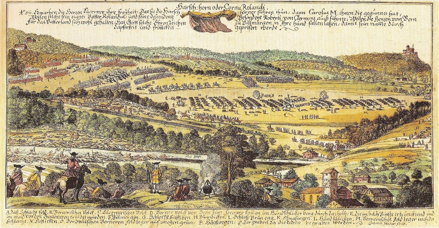 Kolorierter Kupferstich der zweiten Schlacht bei Villmergen 1712: eine weite Hügellandschaft mit aufmarschierten Truppenreihen, Zeltlagern und Dörfern, im Vordergrund Reiter und Offiziere, oben und unten handschriftliche Erläuterungen